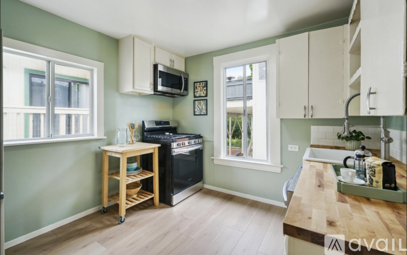 A kitchen with a wooden table and a black oven.