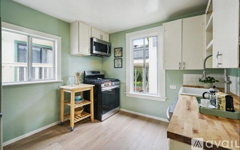 A kitchen with a wooden table and a black oven.