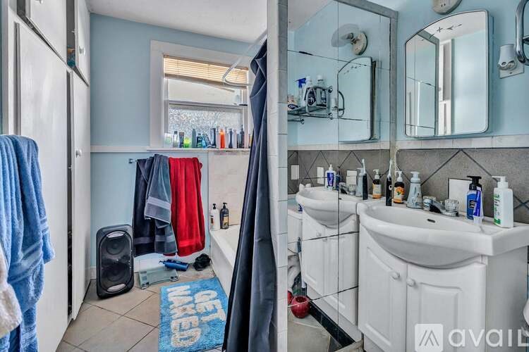A bathroom with a sink, mirror, and towel rack.