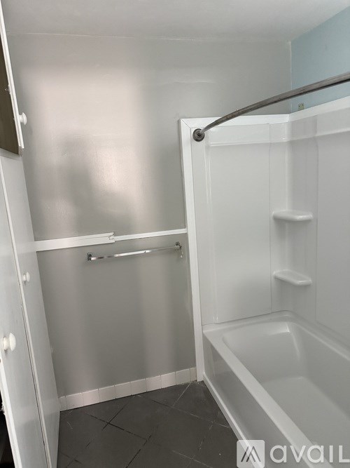 A white bathroom with a tub and a walk in shower.