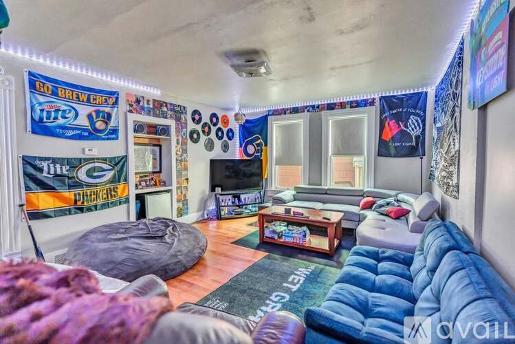A room with a blue couch and a bean bag chair.