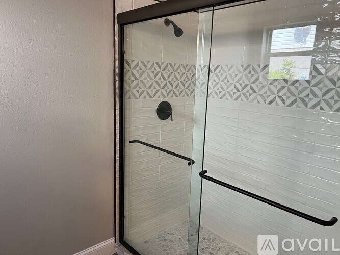 A glass door with a handle and a black frame.