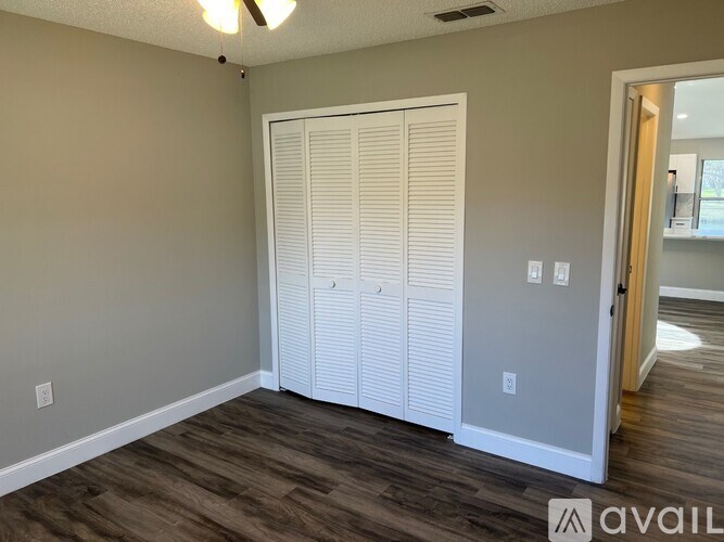A room with a sliding door and wooden flooring.