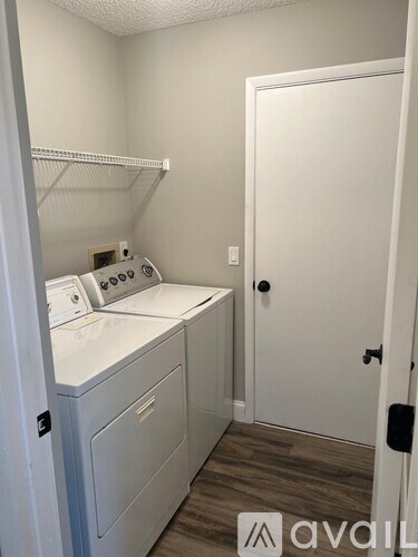 A small laundry room with a washer and dryer.