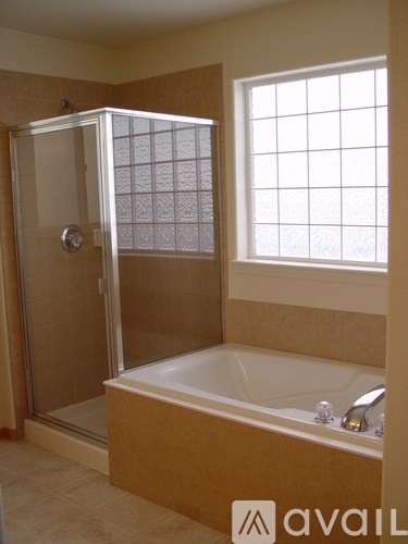 A bathroom with a tub and shower.