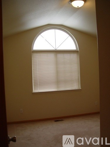 A room with a window covered in blinds.