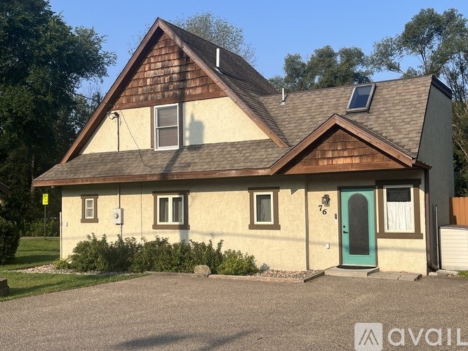 A house with a blue door and a window is for sale.
