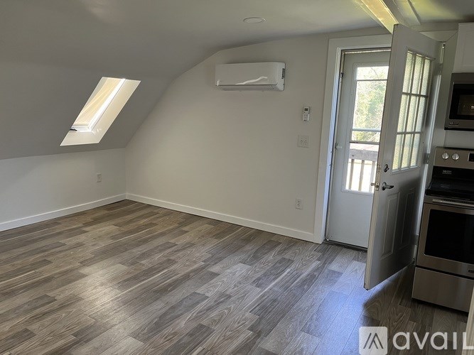 A kitchen with a stove top oven and a window.