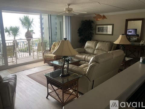 A living room with a glass table and a sofa.