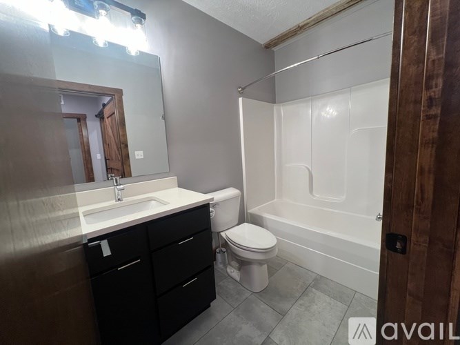 A bathroom with a toilet, sink, and bathtub.