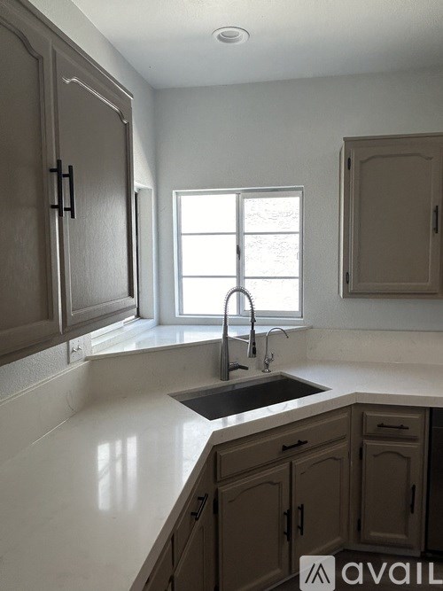 A kitchen with a sink and a window.