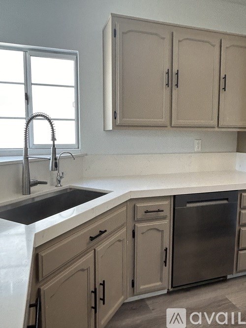 A kitchen with a sink and cabinets.