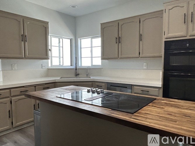A kitchen with wooden countertops and cabinets.