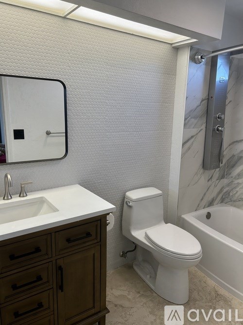 A white toilet sits next to a sink in a bathroom.
