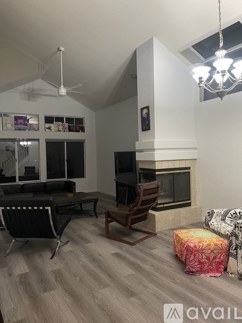 A living room with a fireplace and a television.