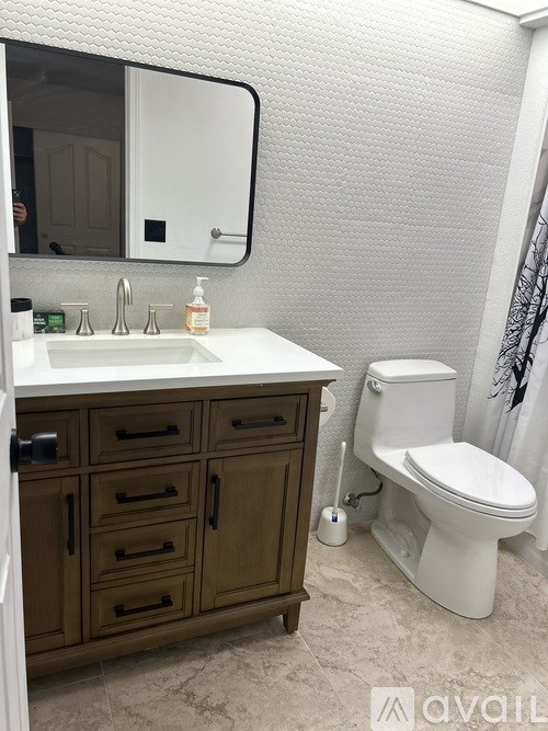A white toilet sits next to a sink in a bathroom.