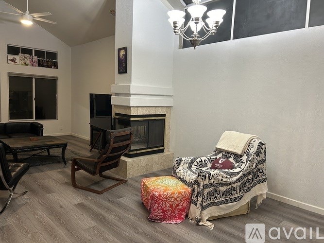 A living room with a fireplace, a chair, and a couch.