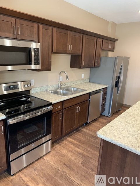 A kitchen with wooden cabinets and stainless steel appliances.
