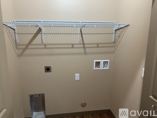 A metal shelf bracket is mounted on a wall.