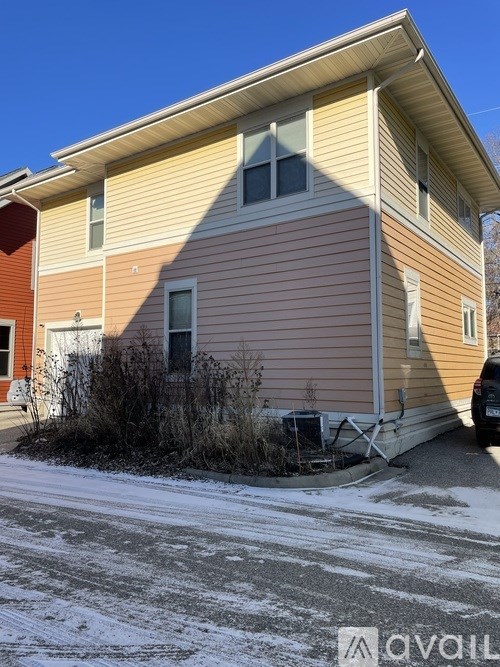 A house with a car parked in front.