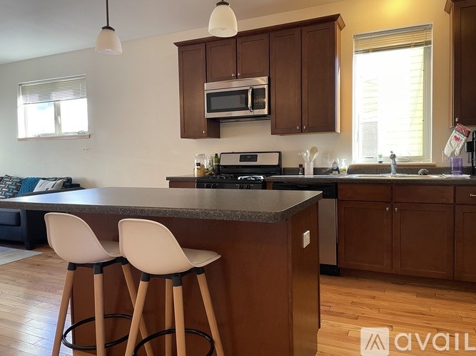 A kitchen with a bar stool and a counter.