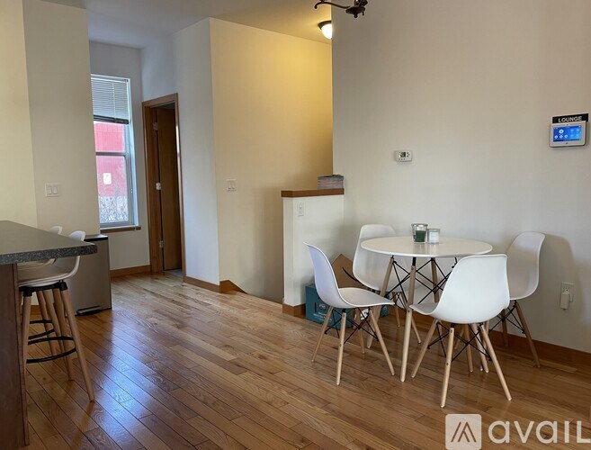 A kitchen with a table and chairs in the middle of the room.