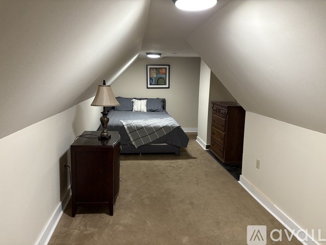 A bathroom with a sink, mirror, and towel rack.