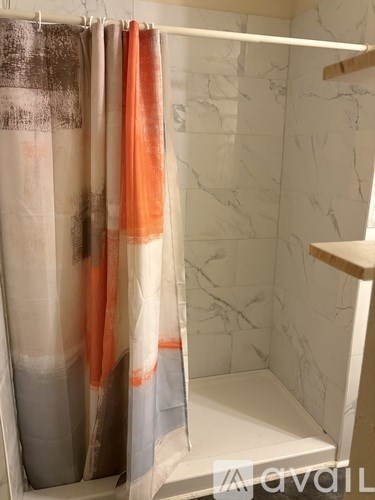 A white door with a black handle and a white cabinet above it.