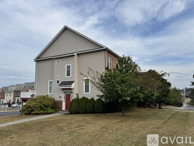 A house with a red door is for sale.