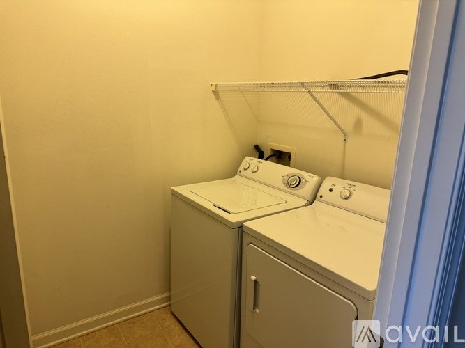 A small laundry room with a washer and dryer.