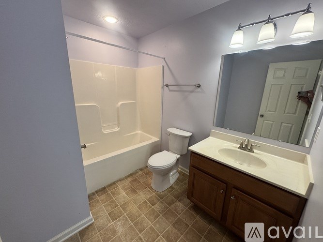 A bathroom with a toilet, sink, and bathtub.