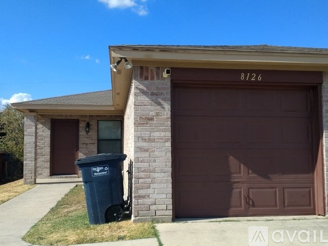 A brown garage door with the number 8126 on it.