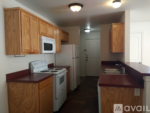 A kitchen with wooden cabinets and white appliances.