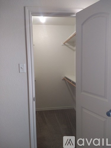 A white door is open to a hallway.