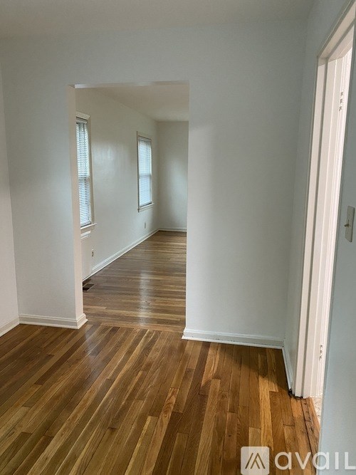 A room with wooden floors and white walls.