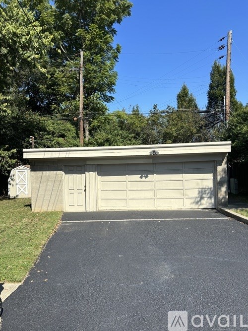 A garage with a driveway in front of it.