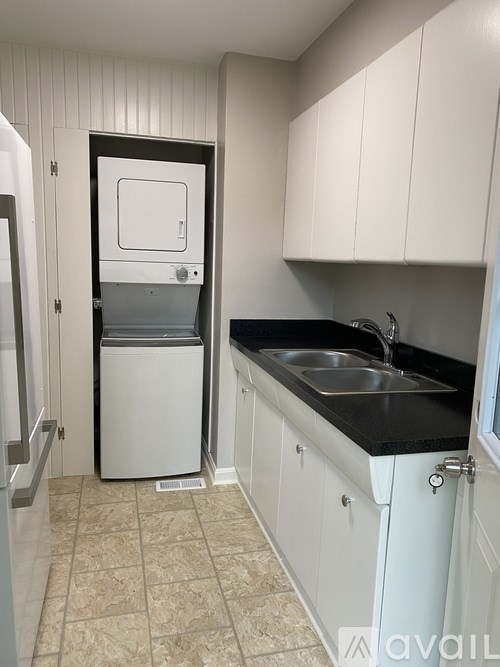 A small kitchen with a sink and a refrigerator.