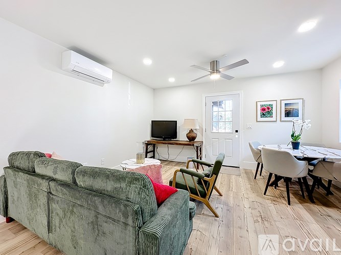 A living room with a green couch and a television.
