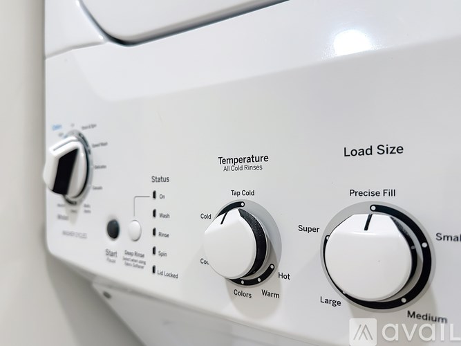 A white washing machine with the temperature and load size dials pulled out.