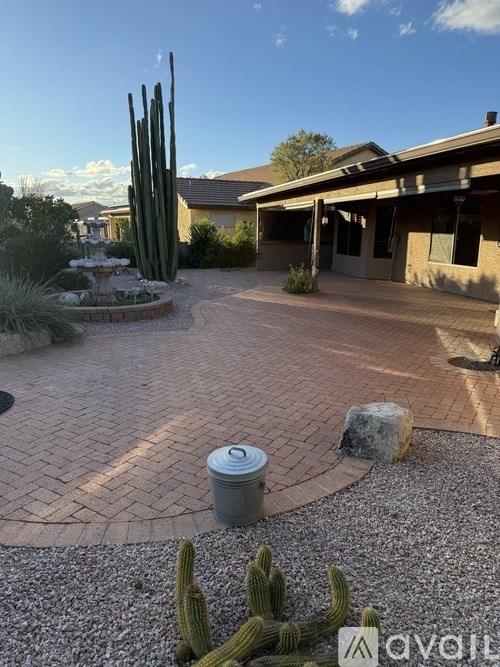 A cactus garden in front of a house.