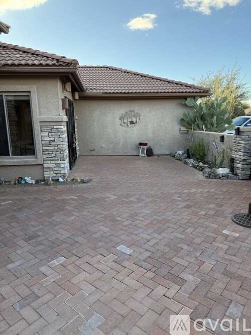 A house with a brick patio in front.