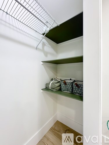 A white shelf with baskets on it.