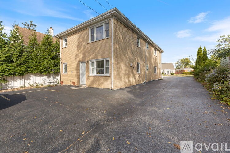 A two-story house with a driveway in front.