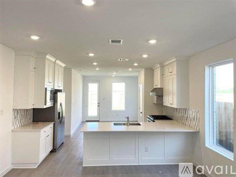 A modern kitchen with white cabinets and a central island.