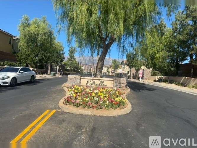 A white car is parked on the side of the road.