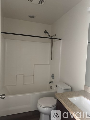 A white toilet sits next to a sink in a small bathroom.