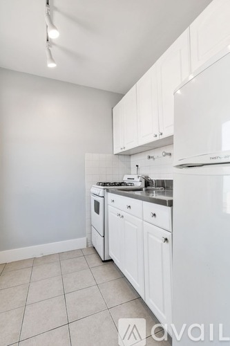 A kitchen with white appliances and cabinets.