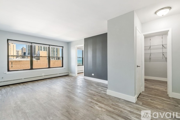 A spacious room with a view of the city through the windows.