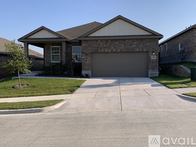 A house with a garage and a driveway in front.