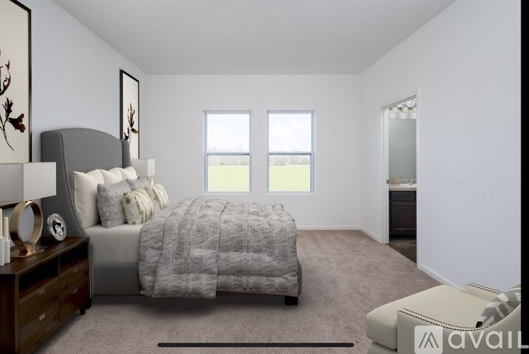 A bedroom with a bed, nightstand, and chair.